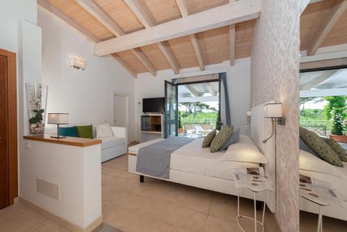 a bedroom with a bed and a living room at Hotel Acapulco in Forte dei Marmi