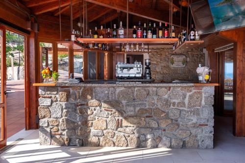 a stone bar in a building with a stone wall at Hotel Baia Imperiale in Campo nell'Elba