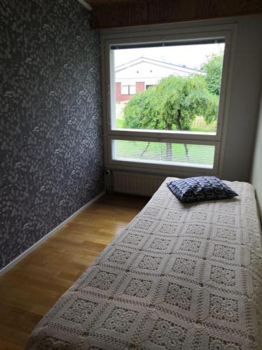 a bedroom with a bed and a large window at RBA RentHouse Apartment 3 in Nedervetil