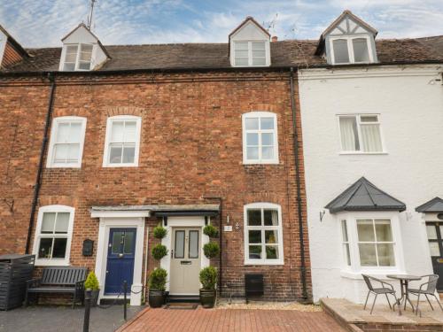 a red brick house with a table in front of it at 5 Riverside in Bridgnorth