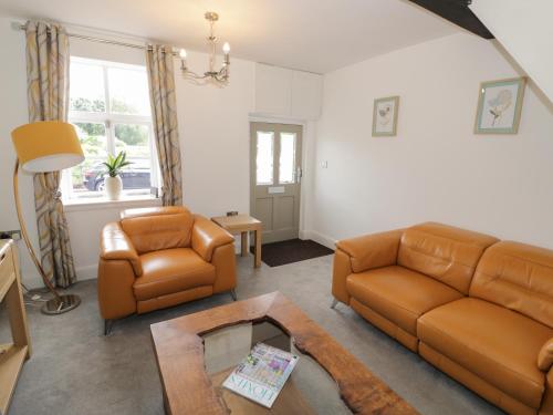 a living room with a couch and a table at 5 Riverside in Bridgnorth