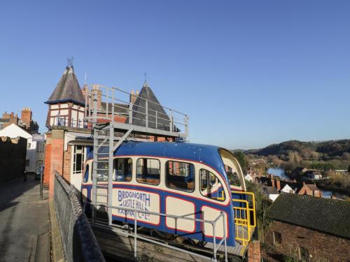 a blue and white train on a bridge at 5 Riverside in Bridgnorth