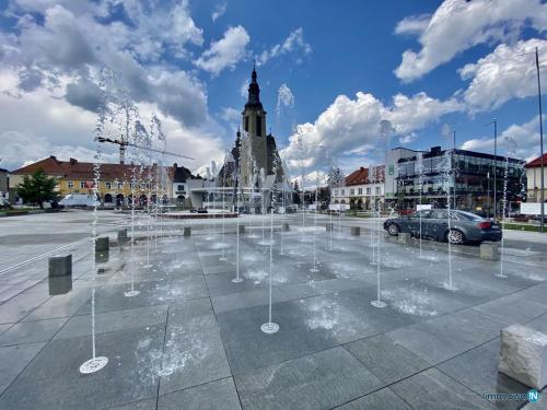 a water fountain in a parking lot in a city at M37 x Fabryczna in Limanowa