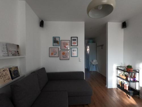 a living room with a couch and pictures on the wall at M37 x Fabryczna in Limanowa