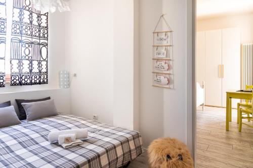 a bedroom with a bed with a dog sitting on the floor at Bed and Breakfast Bric & Brac in Grottammare
