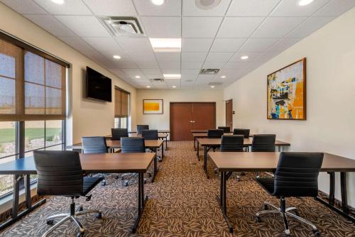 a conference room with tables and chairs and a tv at Comfort Suites Broomfield-Boulder-Interlocken in Broomfield