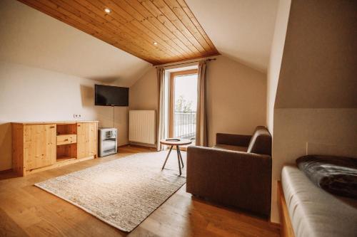 a living room with a couch and a table and a window at Weinhotel Maitz Wolfgang in Ratsch an der Weinstraße