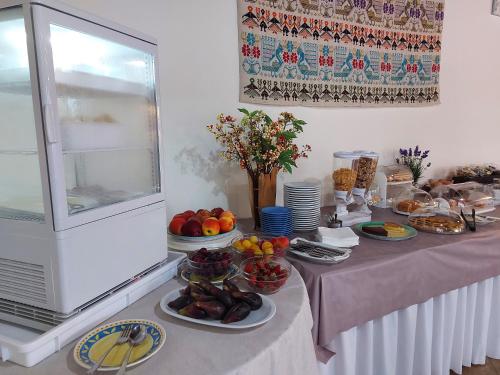 a table with plates of food on top of it at Hotel Plammas in Santa Maria Navarrese