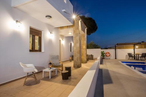 a villa with a swimming pool at night at MonaLisa Villa in Pefki Rhodes
