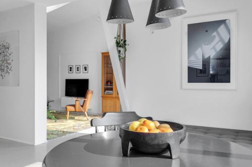a bowl of fruit on a table in a living room at Eyvindarholt Guesthouse in Álftanes