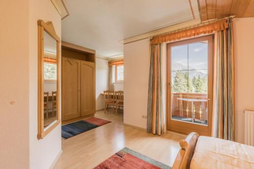an open living room with a large window at Landhaus Kristall in Leutasch