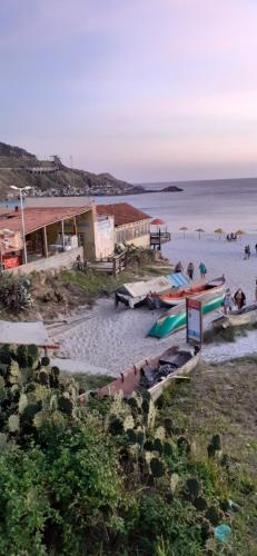 un groupe de personnes sur une plage près de l'eau dans l'établissement PARAÍSO TOM DO MAR 2, à Arraial do Cabo