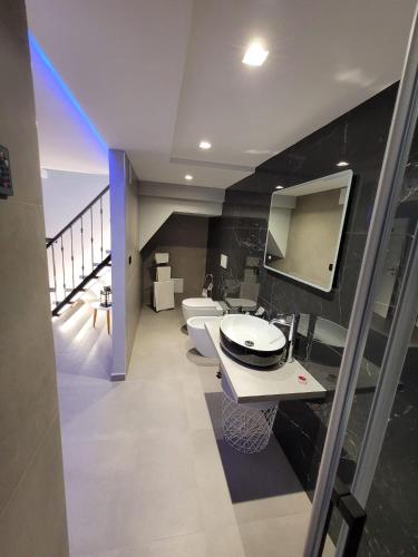 a bathroom with two toilets and a sink and a mirror at Raggio di sole in Bari