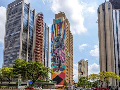 a mural on the side of a building in a city at ibis Styles SP Faria Lima in Sao Paulo