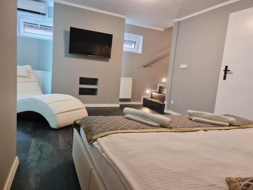two beds in a room with a tv on a wall at Apartament dwupoziomowy Kłodzko - Centrum in Kłodzko