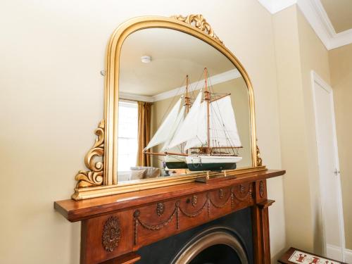 a mirror over a fireplace with a boat in it at Regent House in Scarborough