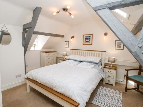 a bedroom with a white bed and a window at Regent House in Scarborough