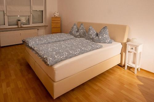 a bedroom with a bed with blue pillows on it at Ferienwohnung im Eisenbergweg in Bad Mergentheim