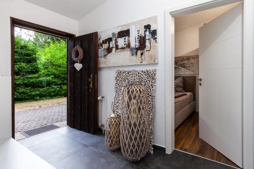 a living room with a chair and a door at Ferienwohnung - Nähe Kaiserslautern in Trippstadt