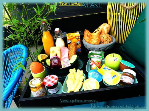 a tray filled with different types of breakfast foods at The Lodge A'PART in Néewiller-près-Lauterbourg
