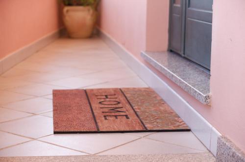 a welcome mat on the floor of a hallway at Casa DàCà in Marrùbiu