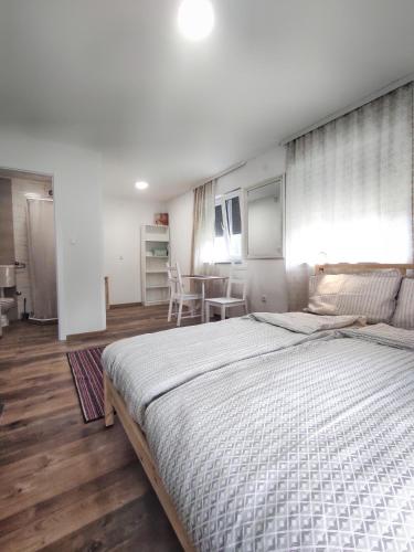 a bedroom with a large bed and a table at Aria Plitvice in Plitvička Jezera