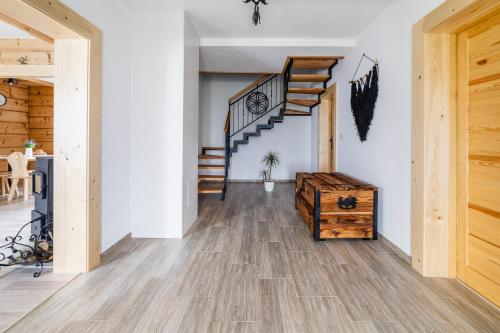 a hallway with wooden floors and a staircase at Domek u Stochów in Biały Dunajec