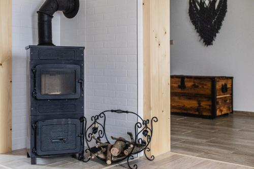 a stove in a room next to a wall at Domek u Stochów in Biały Dunajec