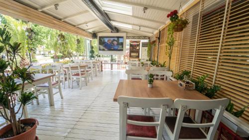 a restaurant with tables and chairs in a room at Saint George Hotel & Medical Spa in Pomorie