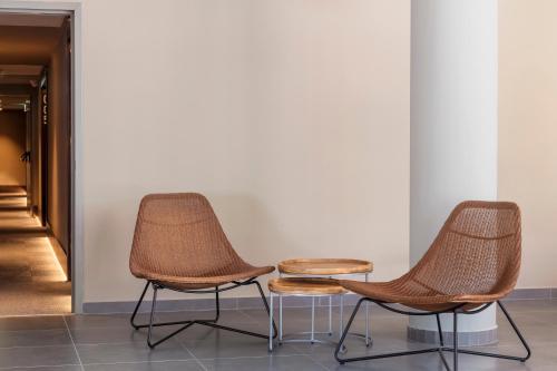 two chairs and a table in a room at B&B HOTEL Lisboa Montijo in Montijo