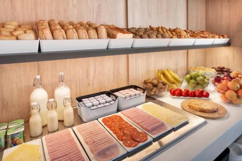 a buffet with lots of different types of food at B&B HOTEL Lisboa Montijo in Montijo