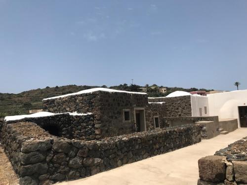 a stone building with snow on top of it at La Grotta di benikula' in Pantelleria