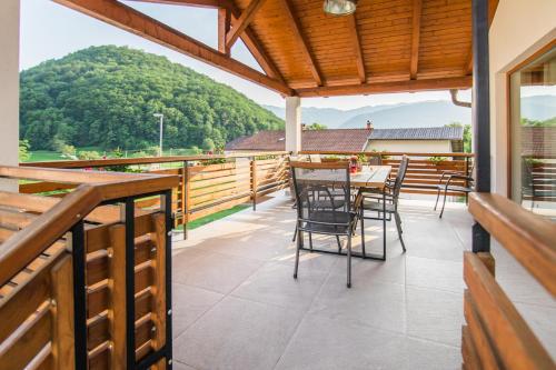 a balcony with a table and chairs and a mountain at Pr' Petrču in Tolmin