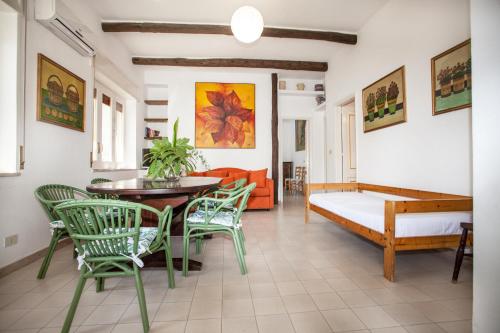 a living room with a table and chairs and a couch at Villaggio Placido in Taormina