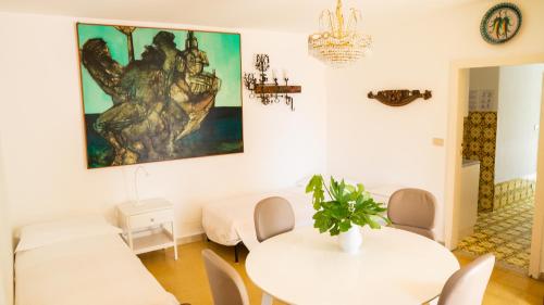 a white living room with a white table and chairs at Villaggio Placido in Taormina