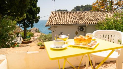 a yellow table with a plate of pastries on it at Villaggio Placido in Taormina