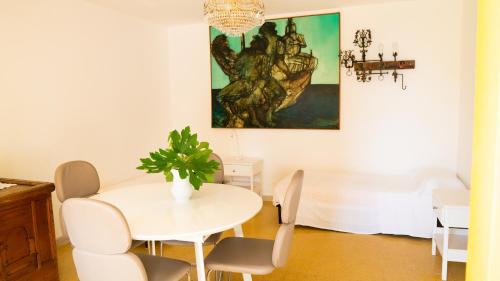a white dining room with a table and chairs at Villaggio Placido in Taormina