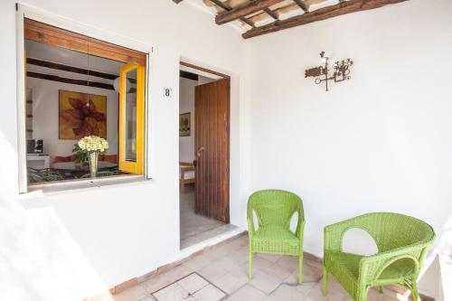 a room with two chairs and a window at Villaggio Placido in Taormina