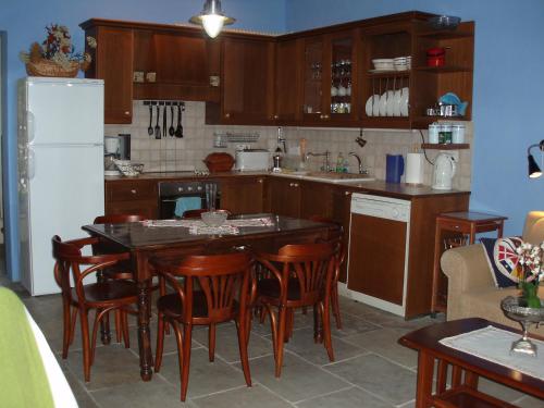 a kitchen with a table and chairs and a refrigerator at Vasilion Agrotourism in Polis Chrysochous
