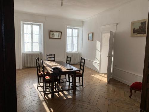 - une salle à manger avec une table et des chaises dans l'établissement Les Jardins d'Élise, calme et verdure à Lure, à Lure