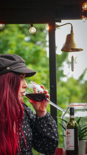 a woman drinking a glass of wine at River Cottage at Old Post Office in Bardon Mill