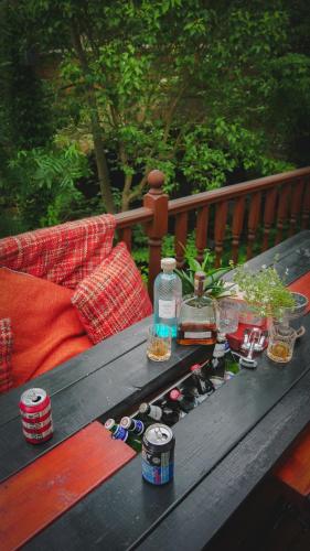 a picnic table with a bunch of bottles on it at River Cottage at Old Post Office in Bardon Mill