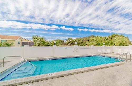 a swimming pool in a backyard with a white fence at Laguna Lookout in Panama City Beach