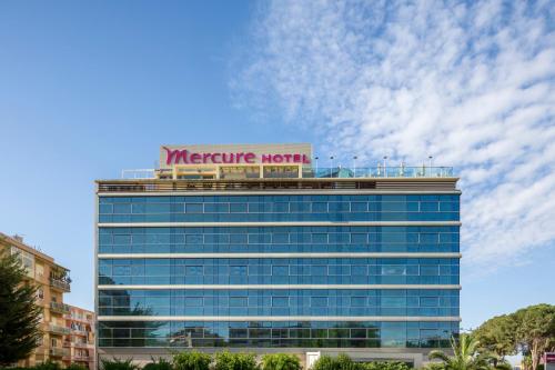 a large building with a sign on top of it at Hotel Mercure Siracusa in Siracusa