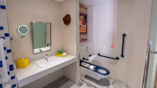 a bathroom with a sink and a mirror and a toilet at LEGOLAND Hotel Dubai in Dubai