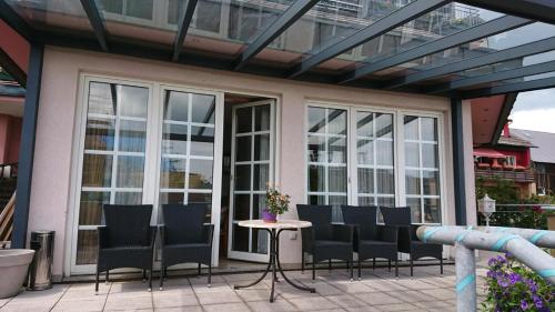 a patio with chairs and a table on a patio at Kloesterle in Bad Steben