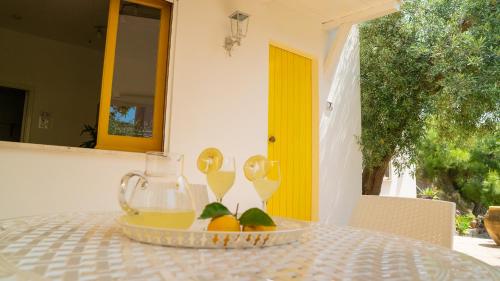a table with a bowl of fruit and a pitcher of juice at Villaggio Placido in Taormina