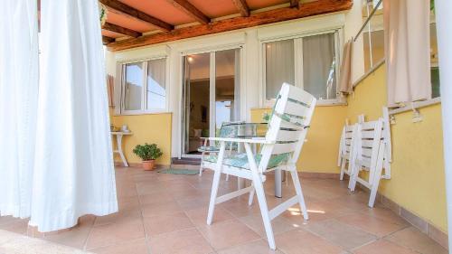 a glass table and two chairs on a balcony at Roko in Novigrad Istria