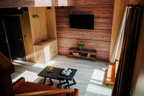 a living room with a television and a table in a room at Aparton in Ustka