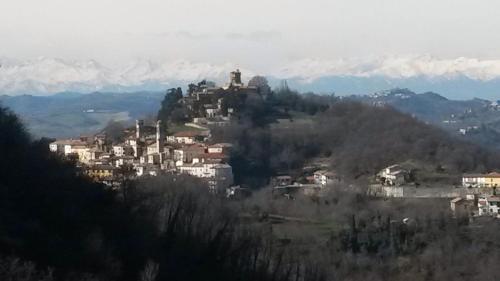 a town on top of a hill with mountains at B&B Monferrato La Casa Sui Tetti in Murisengo
